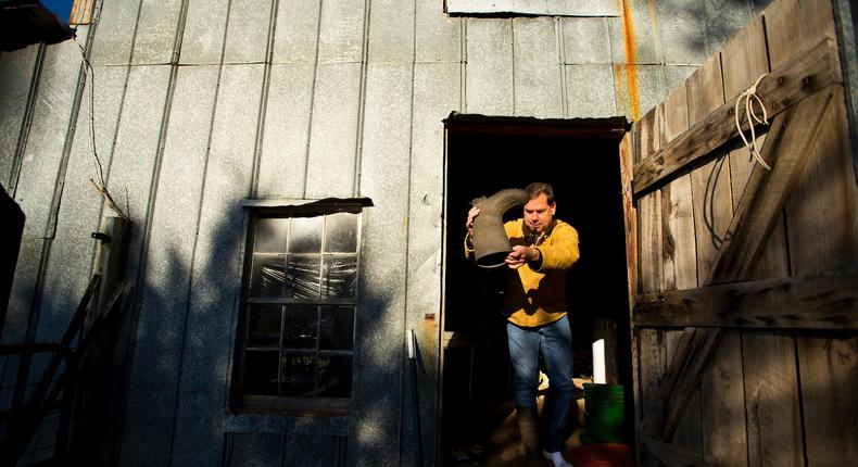 Jeff Nice empties his boot of dried corn at his farm in Kinston, North Carolina.