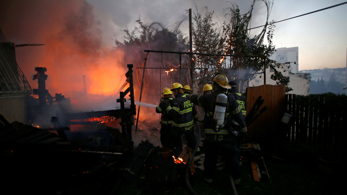 Firefighters work as a wildfire burns in the northern city of Haifa, Israel