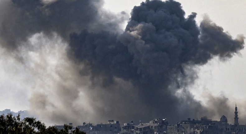 A picture taken from Sderot shows smoke plumes rising above buildings during an Israeli strike on the northern Gaza Strip.ARIS MESSINIS/AFP via Getty Images