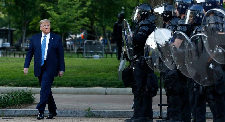 President Donald Trump walks past police in Lafayette Park after visiting outside St. John's Church across from the White House Monday, June 1, 2020, in Washington. Part of the church was set on fire during protests on Sunday night. (AP Photo/Patrick Semansky)