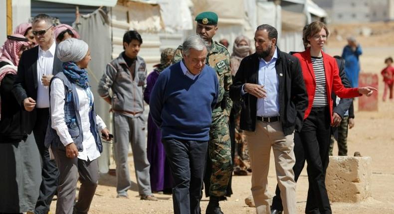 United Nations Secretary General Antonio Guterres (C) walks during a visit to the Zaatari refugee camp which shelters some 80,000 Syrian refugees on the Jordanian border with war-ravaged Syria on March 28, 2017