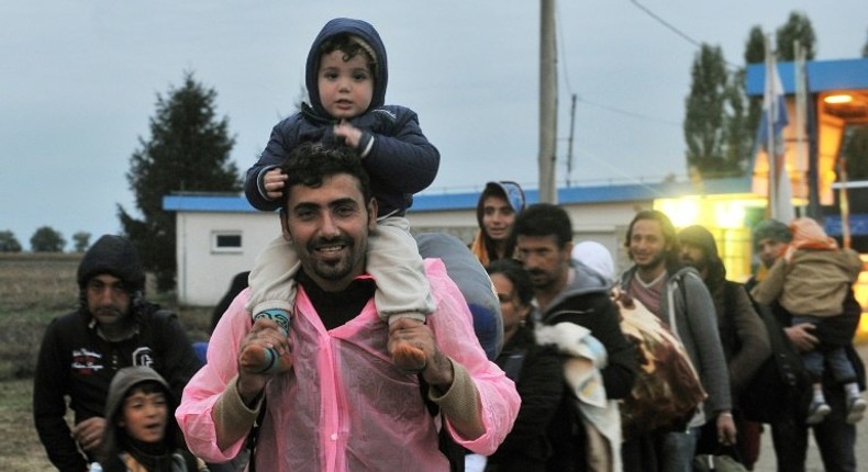 A group of Middle-Eastern migrants walk before crossing the Croatian-Hungarian border in the village of Baranjsko Petrovo Selo, near North-Eastern Croatian town of Beli Manastir, on September 29, 2015