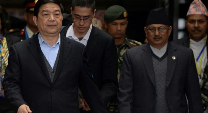 China's Defence Minister Chang Wanquan (L) is escorted by Nepalese officials after his arrival at Tribhuwan International Airport in Kathmandu on March 23, 2017
