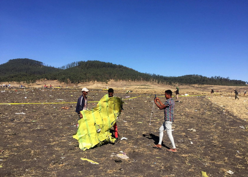 A civilian takes a photograph of the wreckage at the scene of the Ethiopian Airlines Flight ET 302 p