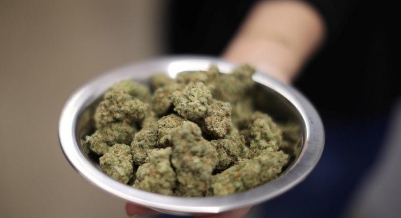 A woman holds marijuana for sale at the MedMen store in West Hollywood