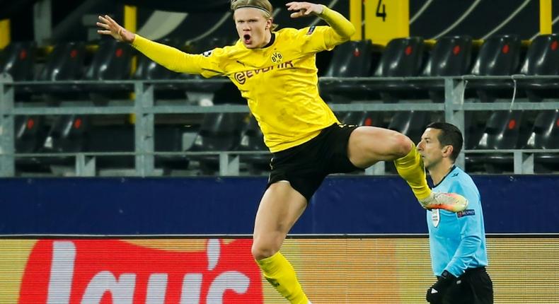 Erling Braut Haaland (R) celebrates scoring his second goal for Borussia Dortmund against Sevilla on Tuesday