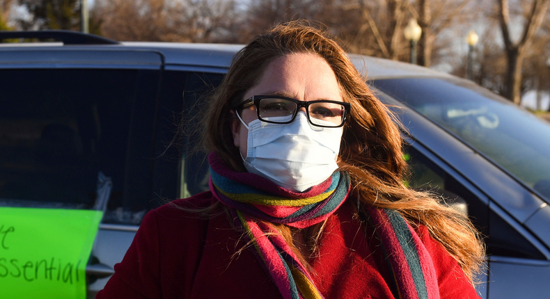 In this Thursday, April 9, 2020 photo, Nancy Reynoza, director of Que Pasa Sioux Falls, who organized a protest in solidarity with Smithfield Food, Inc. employees after many workers complained of unsafe working conditions due to the COVID-19 outbreak in Sioux Falls, S.D. The pork processing plant in South Dakota is closing temporarily after more than 80 employees tested positive for the coronavirus.  (Erin Bormett/The Argus Leader via AP)