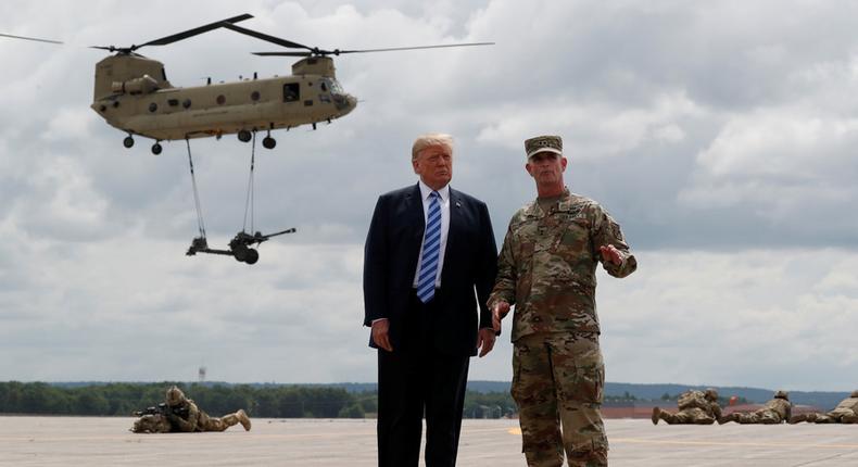 US President Donald Trump (L) watches an air assault exercise with Army Major General Walter Piatt at Fort Drum, New York, on August 13, 2018