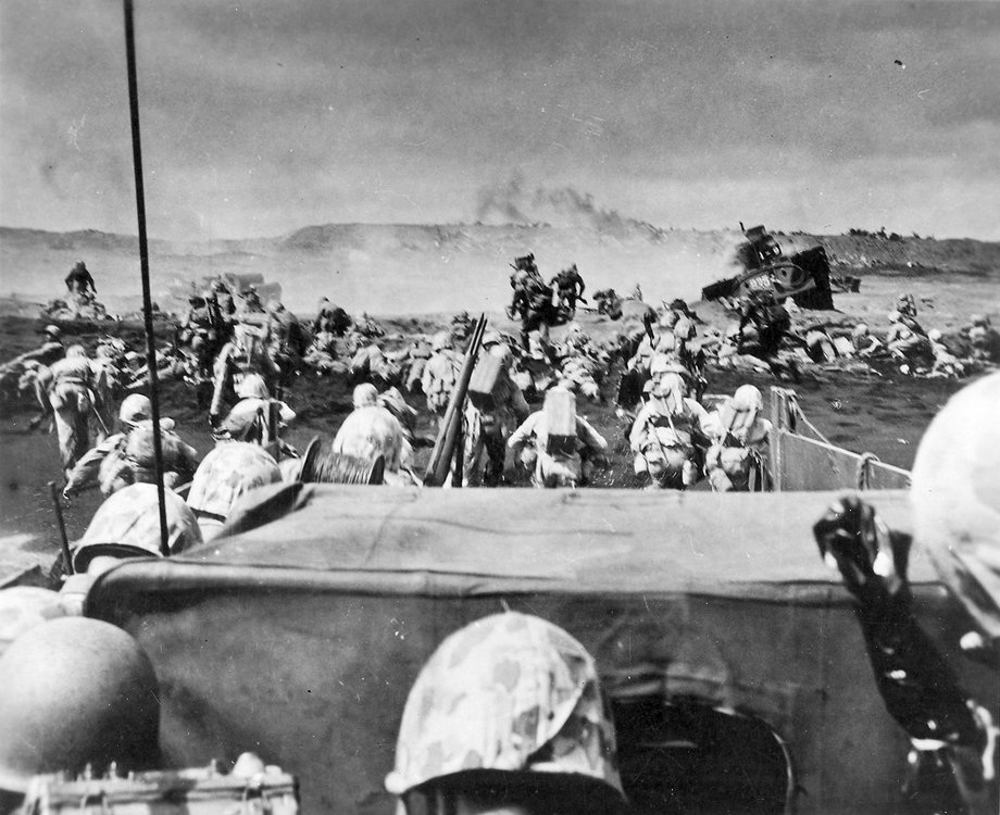 United States Marines rush ashore from their landing craft under heavy fire. Iwo Jima, Japanese Volcano Islands. 19th of February 1945.