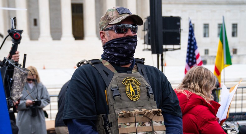 WASHINGTON, DC - JANUARY 05: A member of the right-wing group Oath Keepers stands guard during a rally in front of the U.S. Supreme Court Building on January 5, 2021 in Washington, DC. Today's rally kicks off two days of pro-Trump events fueled by President Trump's continued claims of election fraud and a last-ditch effort to overturn the results before Congress finalizes them on January 6.Robert Nickelsberg/Getty Images