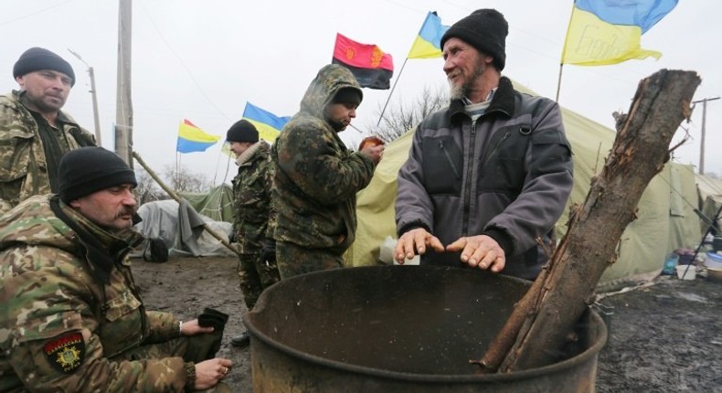 Ukrainian nationalist protesters and military veterans take part in a blockade against ongoing trade with Russian-backed insurgents at Kryvyi Torets railway station, in the Donetsk region, on February 23, 2017 The blockade consists of four different camps where scores of activists man checkpoints across roads and railway lines connecting government territory to the two self-proclaimed rebel republics. Activists say they're blocking an illegal trade in coal, metals, timber, cigarettes and alcohol that is helping to fund the insurgents and keep Ukraine's war grinding on.