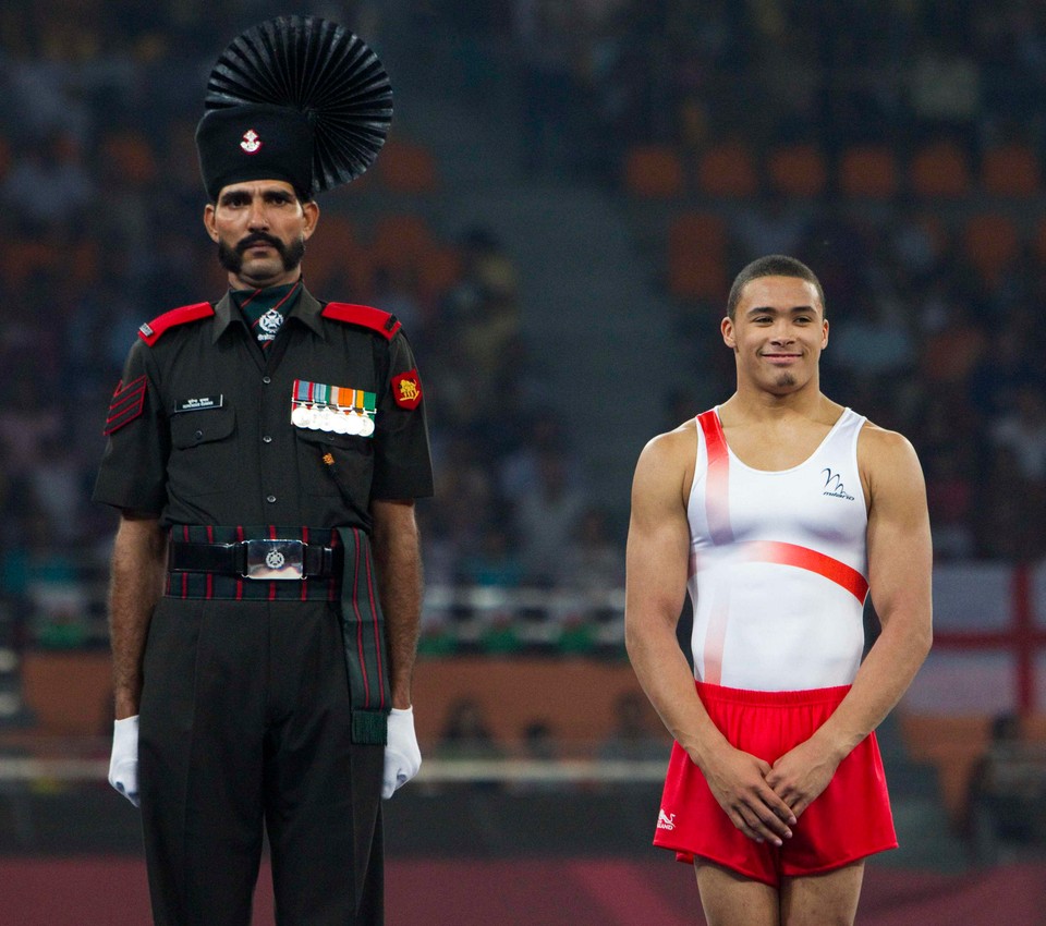 England's Beckford waits to receive his silver medal for the men's gymnastics floor exercise event at the Commonwealth Games in New Delhi