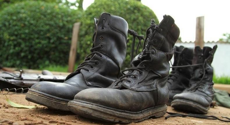 Military boots are displayed after they were recovered from suspected fighters following clashes in the capital Bujumbura, Burundi December 12, 2015. REUTERS/Jean Pierre Aime Harerimana