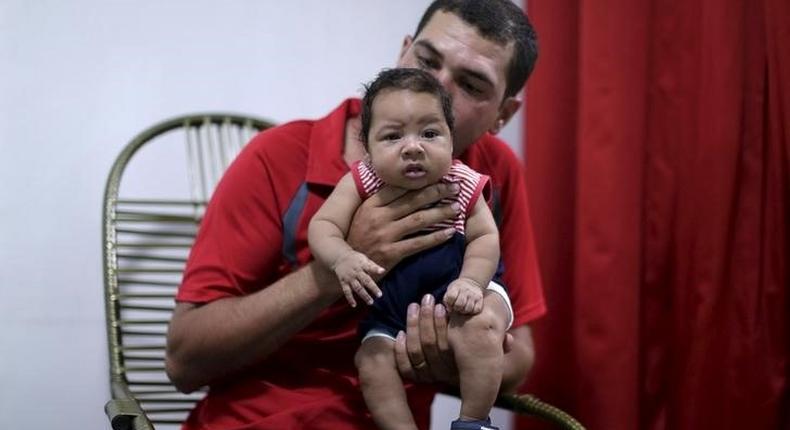 Glecion Fernando holds his 2 month old son Guilherme Soares Amorim, who was born with microcephaly, near at her house in Ipojuca, Brazil, February 1, 2016. REUTERS/Ueslei Marcelino