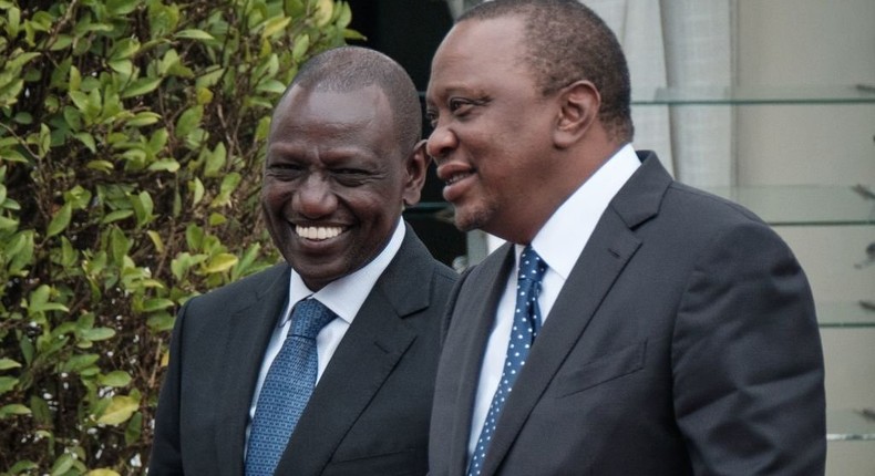 Uhuru Kenyatta (R) an William Ruto walk for the arrival of the British Prime Minister at the State House in Nairobi on August 30, 2018. (Photo by YASUYOSHI CHIBA/AFP via Getty Images)