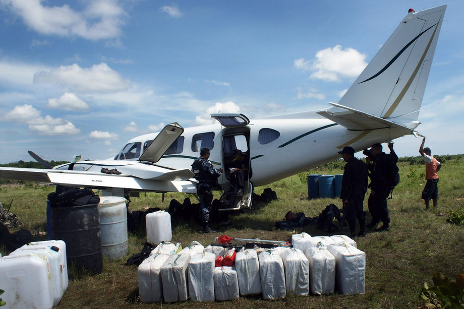 Honduran police with a privately owned plane that was seized after it was found to be holding 450 kilos of drugs in Brus Laguna, Honduras, 372 miles east of Tegucigalpa, along the border with Nicaragua, July 22, 2010.