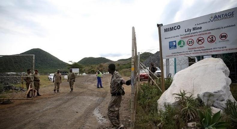 Security guards keep watch at the entrance of the Lily mine, which is owned by Vantage Goldfields, near Barberton, east of Johannesburg, February 5, 2016. 