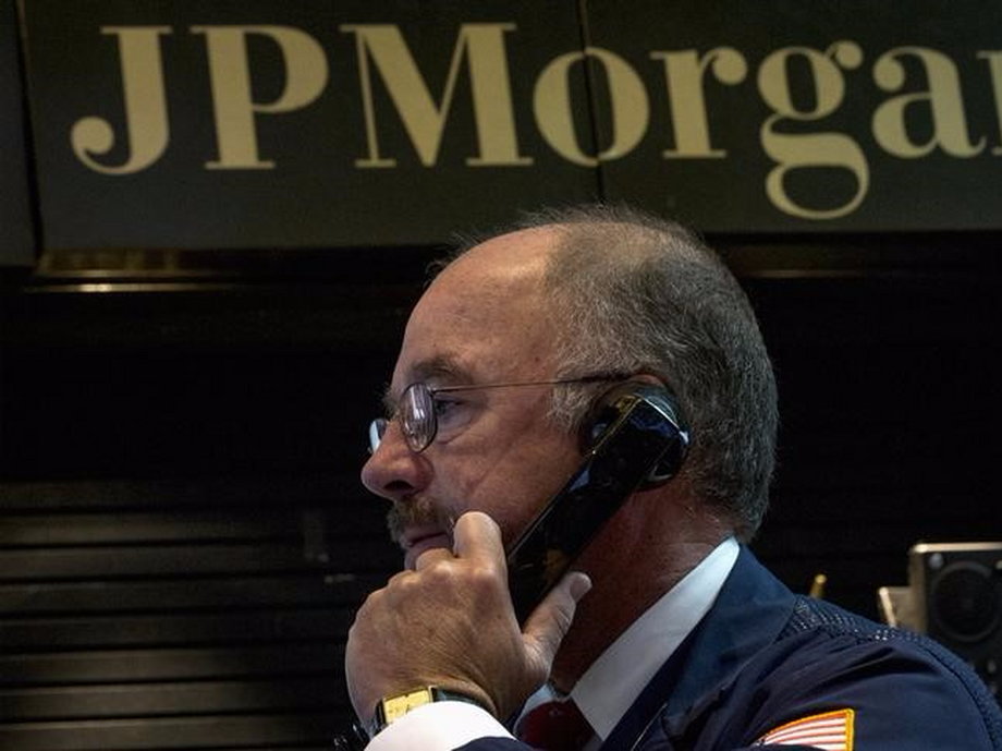 JPMorgan Chase trader Frederick Reimer works in the company's stall on the floor of the New York Stock Exchange