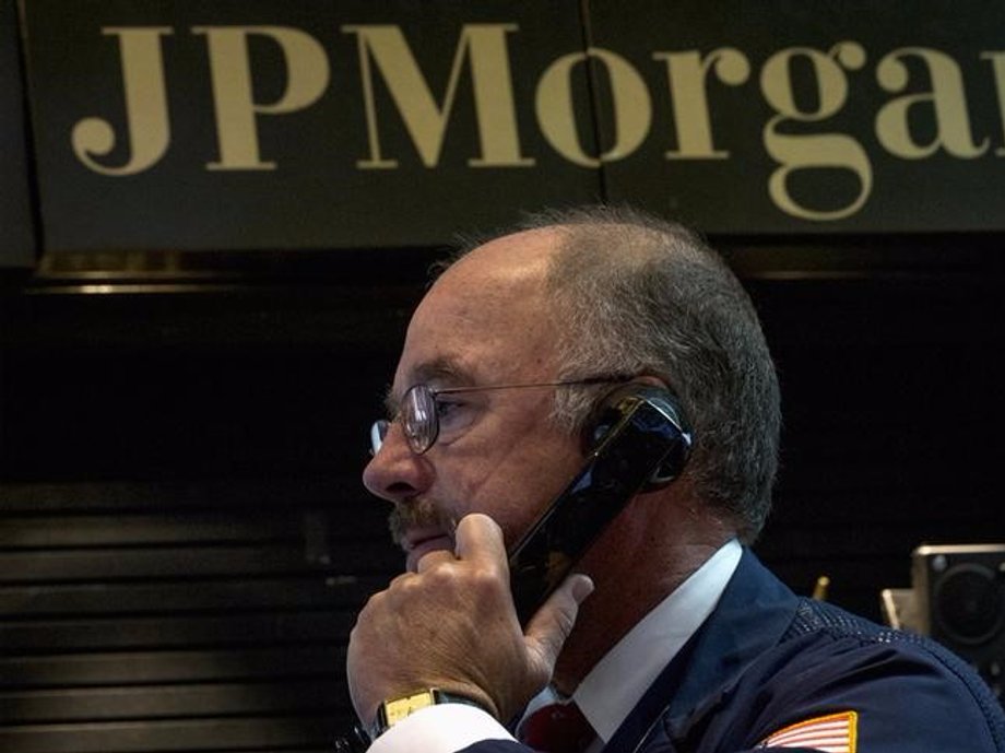 JPMorgan Chase trader Frederick Reimer works in the company's stall on the floor of the New York Stock Exchange