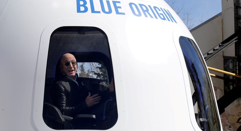 Jeff Bezos gestures from inside a Blue Origin New Shepard capsule, similar to the kind he traveled in to the edge of space.Isaiah J. Downing/Reuters