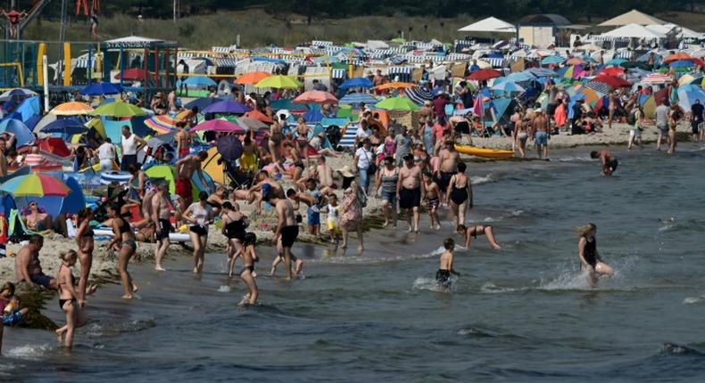 Despite COVID-19 fears, people enjoy warm summer weather at a beach near the Baltic Sea village of Binz, northern Germany