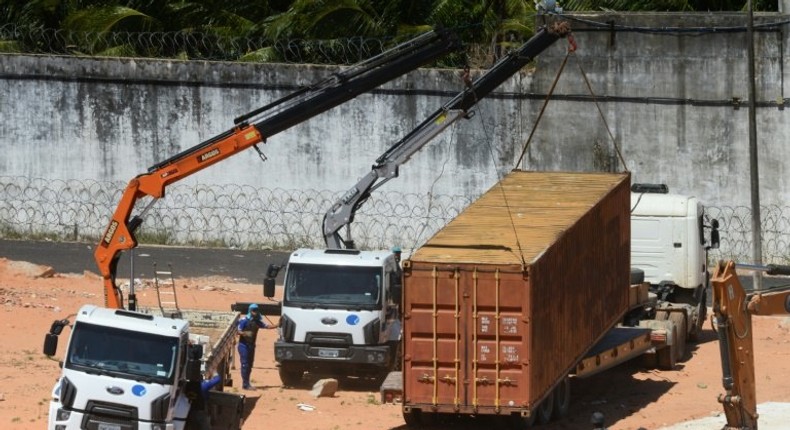 Police build a barrier using containers to separate rival factions after violent clashes between gangs in the Alcacuz Penitentiary Center near Natal in Rio Grande do Norte, Brazil, on January 21, 2017