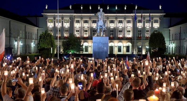 People gather for a protest in front of the presidential palace in Warsaw on July 18, 2017 urging the Polish president to reject a bill changing the judiciary system