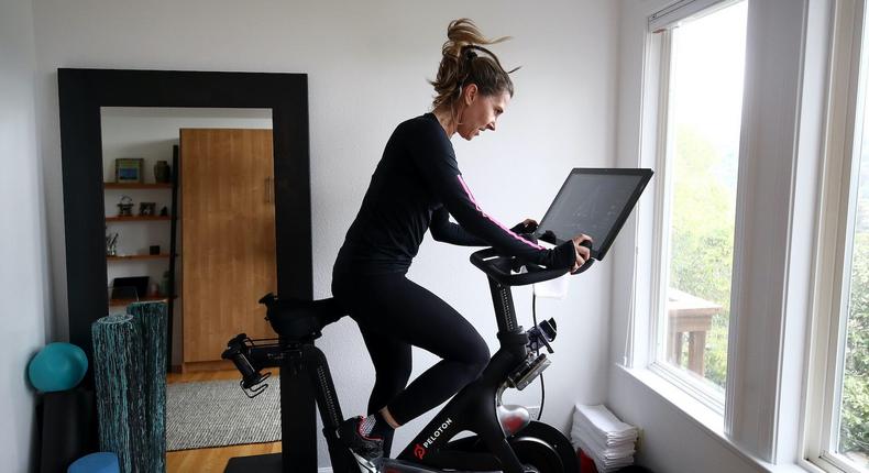 Cari Gundee rides her Peloton exercise bike at her home on April 6, 2020, in San Anselmo, California.