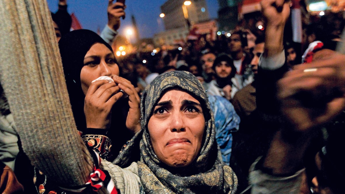 TURNING OF THE TIDE Above: a woman in Cairo’s Tahrir Square in 2011 after President Hosni Mubarak said he would step down.