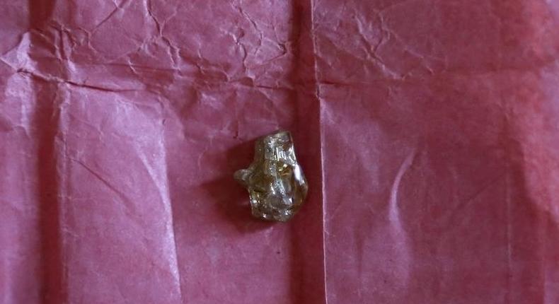 A rough diamond, from the Boda region in Central African Republic, is displayed for sale in Bangui May 1, 2014. 