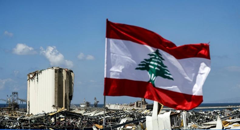 A Lebanese flag flies on a bridge near the port of Lebanon's capital Beirut, amid the destruction of Tuesday's explosion that killed over 150