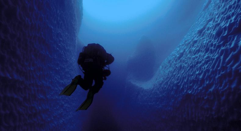 Paul Heinerth rises out of a cave inside a fragment of iceberg B15, which calved from Antarctica in the spring of 2000.Jill Heinerth