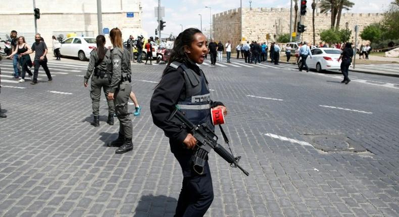 Israeli security forces gather at the site of a stabbing in Jerusalem on April 14, 2017