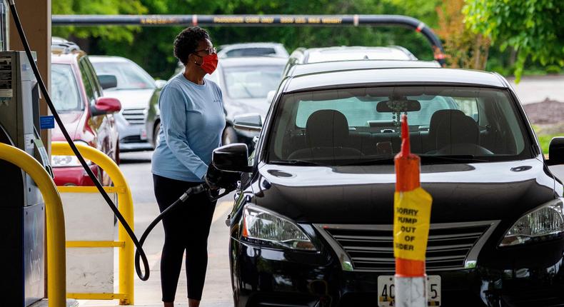 Stock image of a woman filling her car with fuel