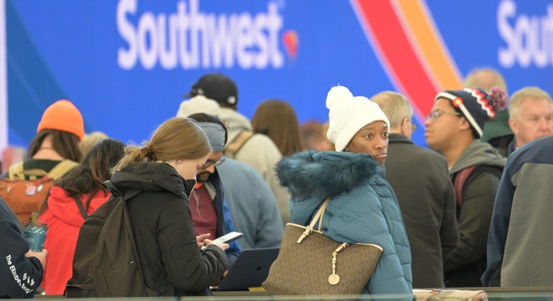 Canceled flight travelers line up in front of Southwest Airlines sign at Denver International Airport.Hyoung Chang/Getty Images