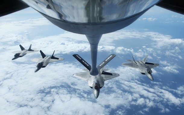 Four F22 Raptors fly in formation after a mid-air refueling exercise with a KC-135R Stratotanker as 