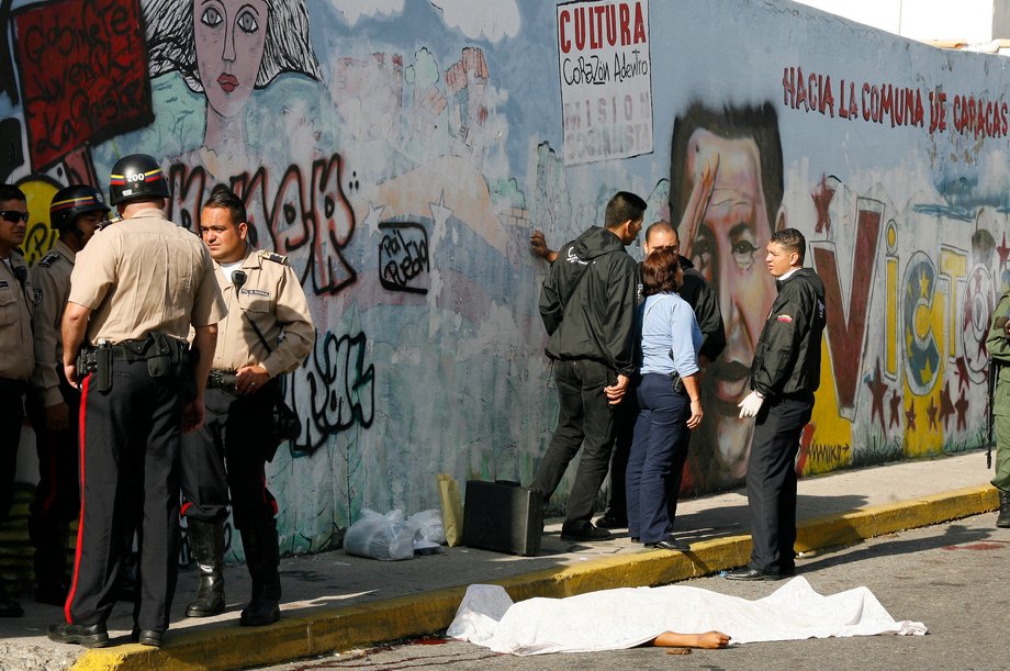 The body of a man lies on the street after he was killed while trying to rob a policeman dressed in plain clothes in Caracas, September 9, 2010.