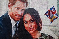 A girl waves a flag next to a LEGO brick mosaic of Britain's Prince Harry and Meghan Markle in Windsor