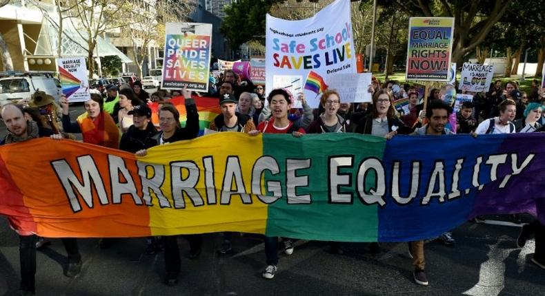 Gay marriage supporters march during a rally in Sydney on June 25, 2016