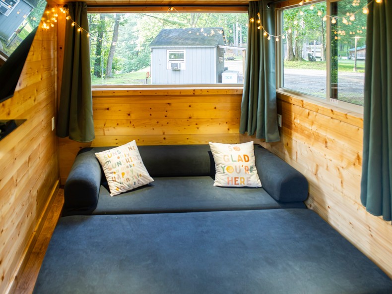 The couch was essentially two large cushions stacked on top of each other. I took them apart and put them side by side on the living room floor, which filled the space.I imagined two people could sleep here with the cushions attached or separated into two cots.