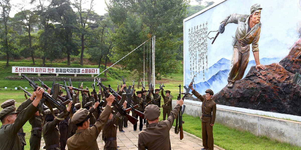 North Koreans signing up to join the army in an undated photo released by North Korea's Korean Central News Agency in Pyongyang.