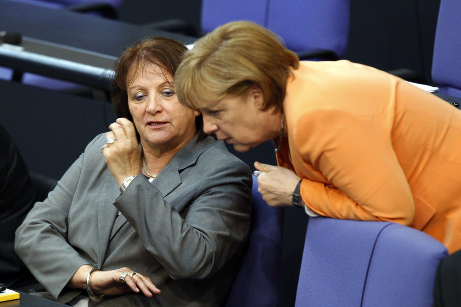 German Chancellor Angela Merkel, right, and Justice Minister Sabine Leutheusser-Schnarrenberger talk during a debate about a proposed resolution on circumcision in Berlin, July 19, 2012.