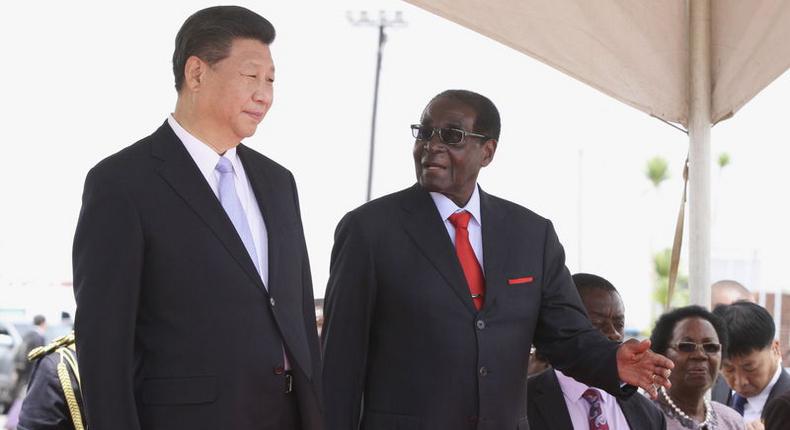 Chinese President Xi Jinping talks with Zimbabwean President Robert Mugabe on arrival for a state visit in Harare, Zimbabwe December 1, 2015. REUTERS/Philimon Bulawayo