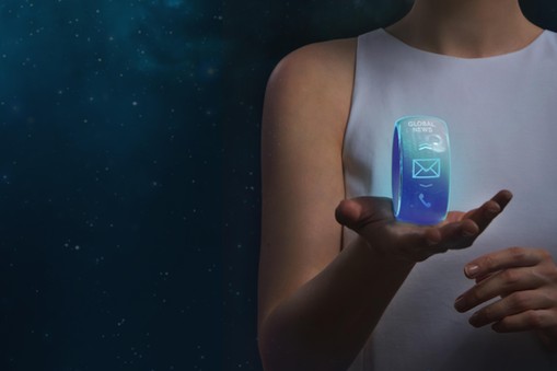 Futuristic unrecognizable woman holding smartwatch on a cosmic background