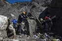 Resuce workers and investigators, seen in this picture made available to the media by the French Interior Ministry work near debris from wreckage at the crash site of a Germanwings Airbus A320, near Seyne-les-Alpes