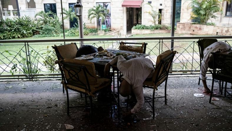 Bodies of victims are seen at a restaurant's terrace after a bomb attack at a Nairobi hotel complex on January 15