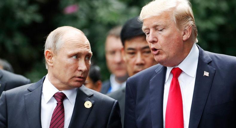 President Donald Trump (R) and Russia's President Vladimir Putin talk as they make their way to take the family photo during the Asia-Pacific Economic Cooperation (APEC) leaders' summit in the central Vietnamese city of Danang on November 11, 2017.JORGE SILVA/POOL/AFP via Getty Images