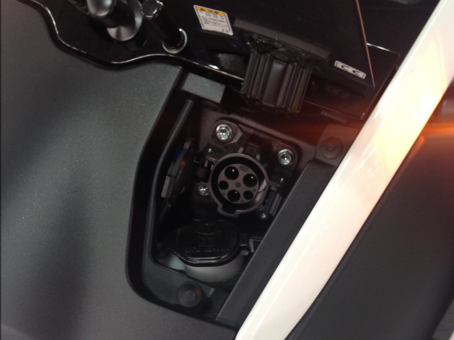 The i-Road is charged through a socket located below the front windshield.