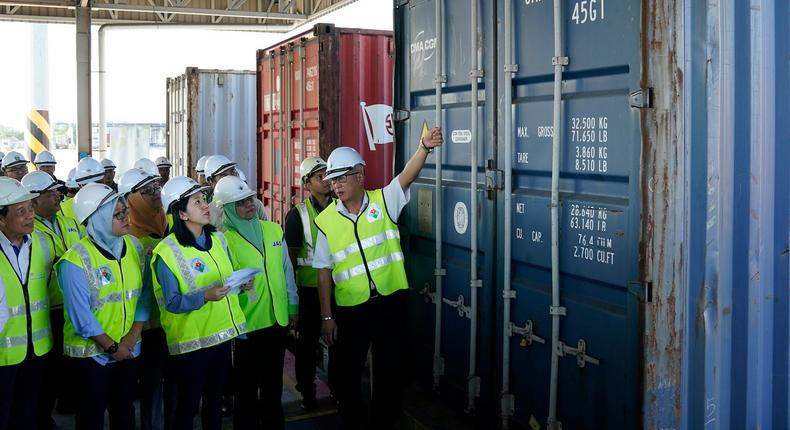 Yeo Bee Yin, third from left, inspects a container with plastic waste at a port in Butterworth, Malaysia, Monday, Jan. 20, 2020.