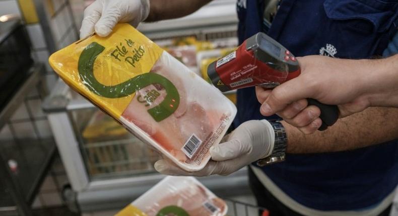 The staff of Rio de Janeiro state's consumer protection agency, PROCON, checks the temperature of frozen chicken products at a supermarket in Rio de Janeiro, Brazil, on March 24, 2017